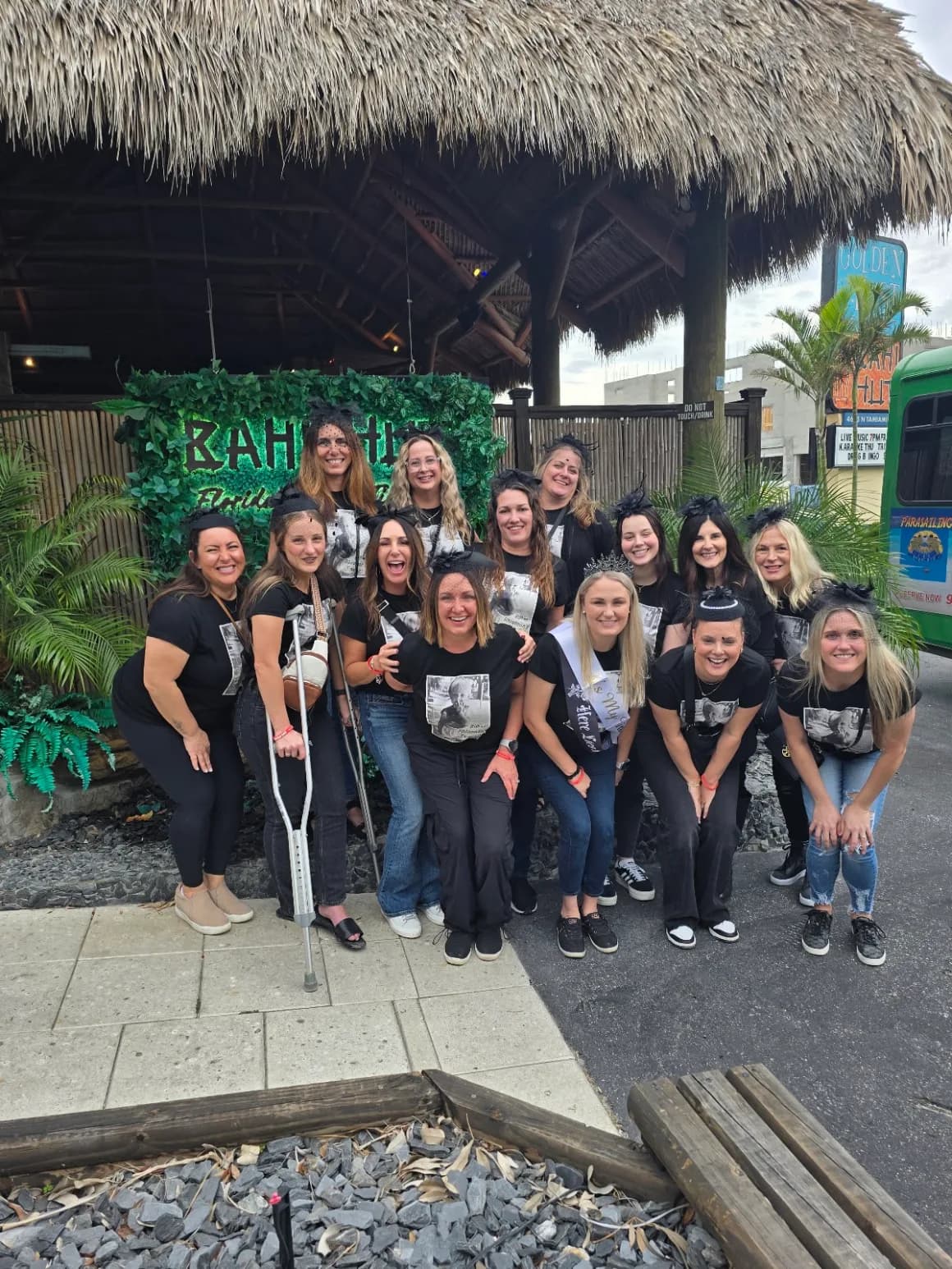 A group of riders posing outside the Bahi Hut tiki bar on Siesta Key